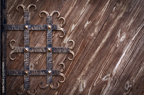 Decorative forged elements on a wooden gate