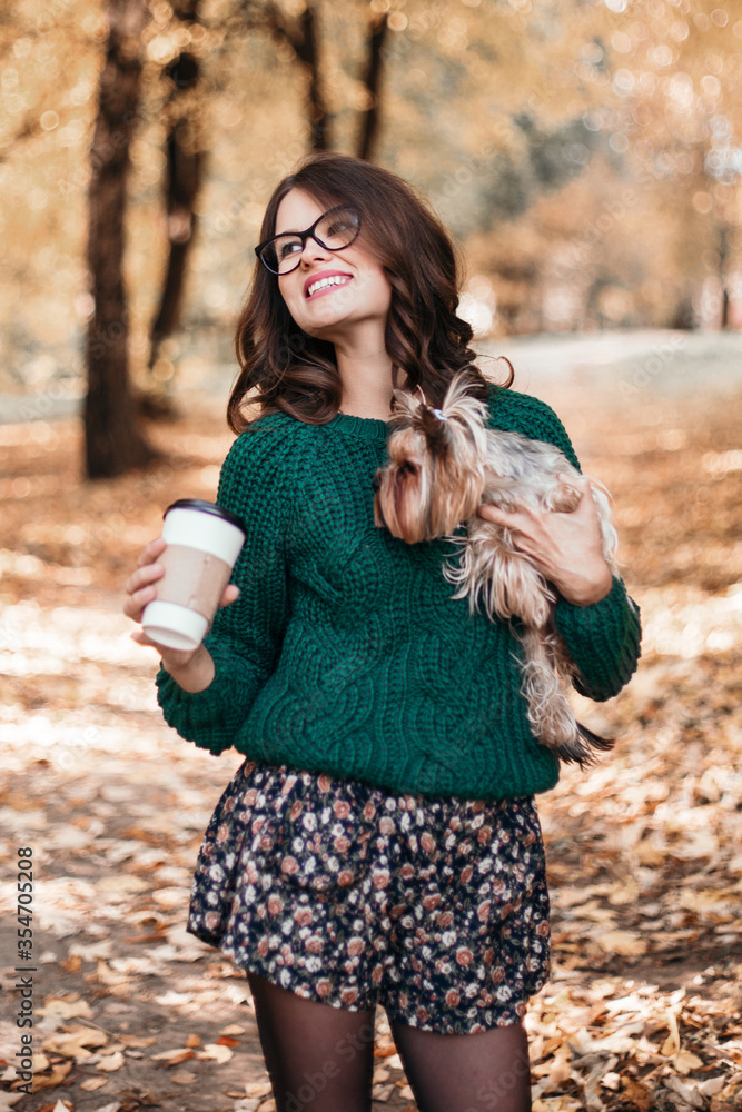 Beautiful woman walk with dog and drink coffee in the park. Beautiful woman walk with dog and drink coffee in the park.