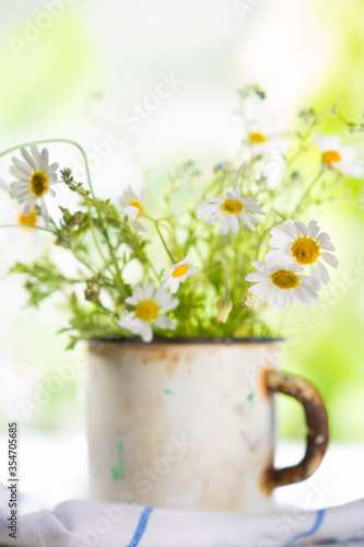 Wildflowers in an old metal mug. Summer concept.