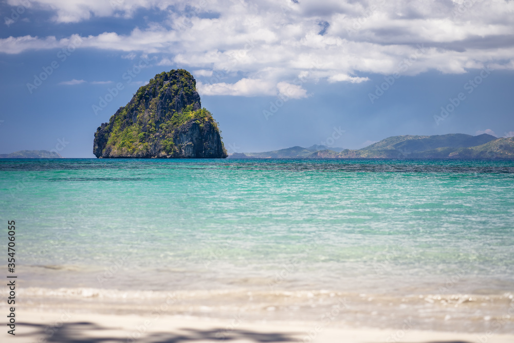 Fototapeta premium El Nido, Palawan, Philippines. Tropical jutted rocky island in open ocean and cloudscape
