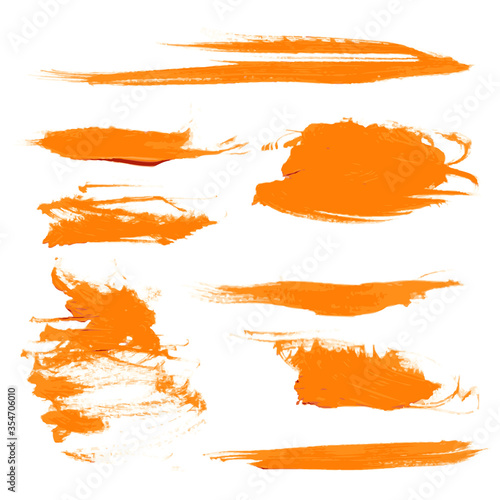 Orange dry brush strokes different shape set isolated on a white background