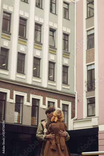 A couple in love hugging in the street wearing vintage loose cloaks in Kiev