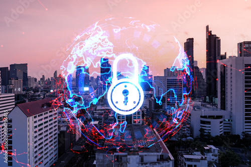 Hologram of Padlock on sunset panoramic cityscape of Bangkok, Asia. The concept of cyber security intelligence. Multi exposure.