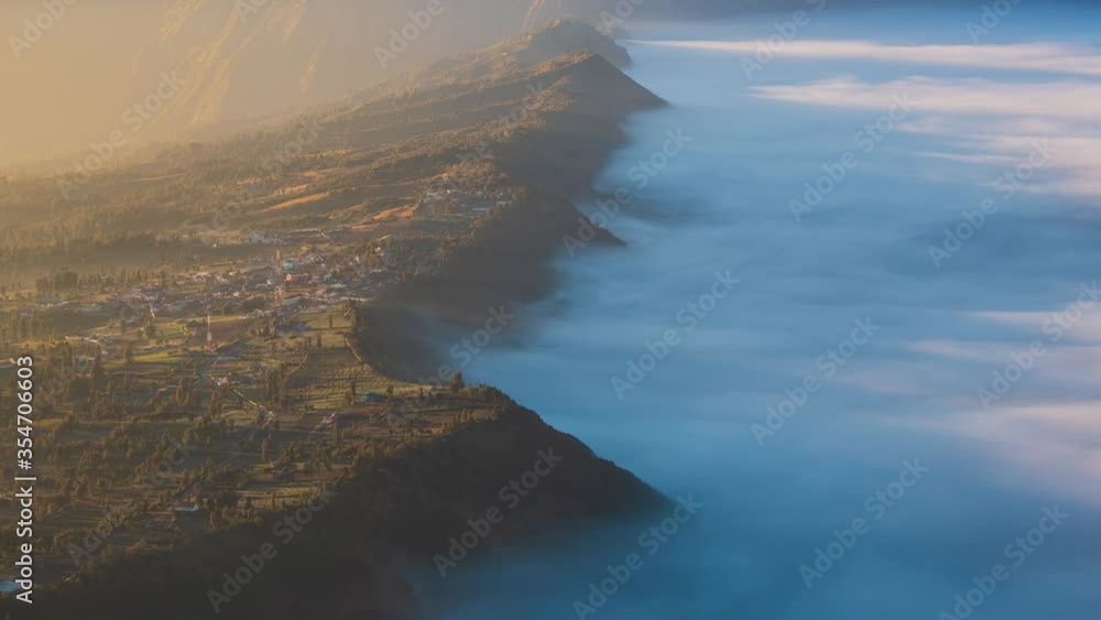 Beautiful Cliff Side Village Sunlight and Misty, Landmark Travel Place of East Java, Indonesia (pan left) Beautiful Cliff Side Village Sunlight and Misty, Landmark Travel Place of East Java, Indonesia (pan left)