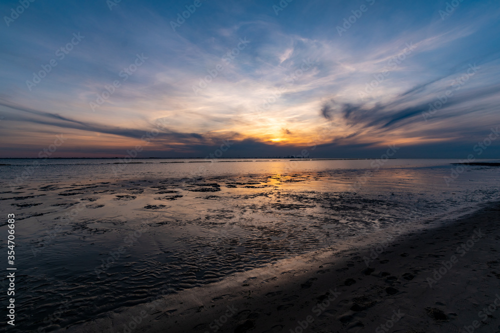 Sunset on the North Sea beach in East Frisia in early summer Sunset on the North Sea beach in East Frisia in early summer