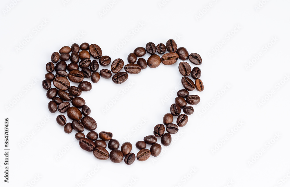Coffee beans laid out in the shape of a heart on a white background Coffee beans laid out in the shape of a heart on a white background