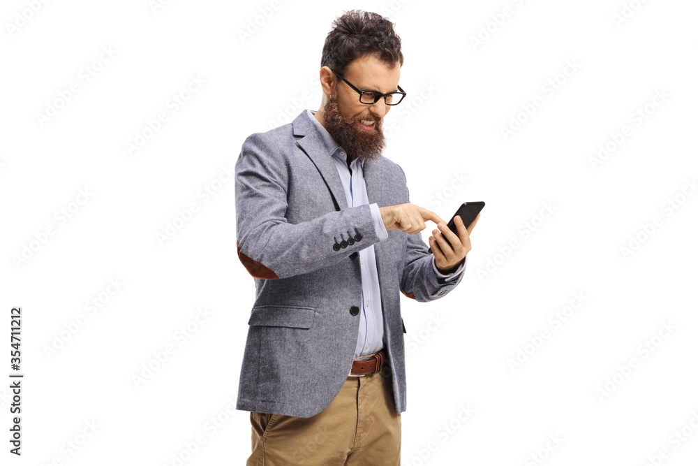 Annoyed bearded man typing on a mobile phone Annoyed bearded man typing on a mobile phone