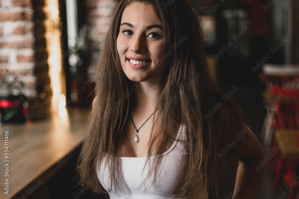 Beautiful woman posing for the camera sitting in a cafe. Beautiful woman posing for the camera sitting in a cafe.