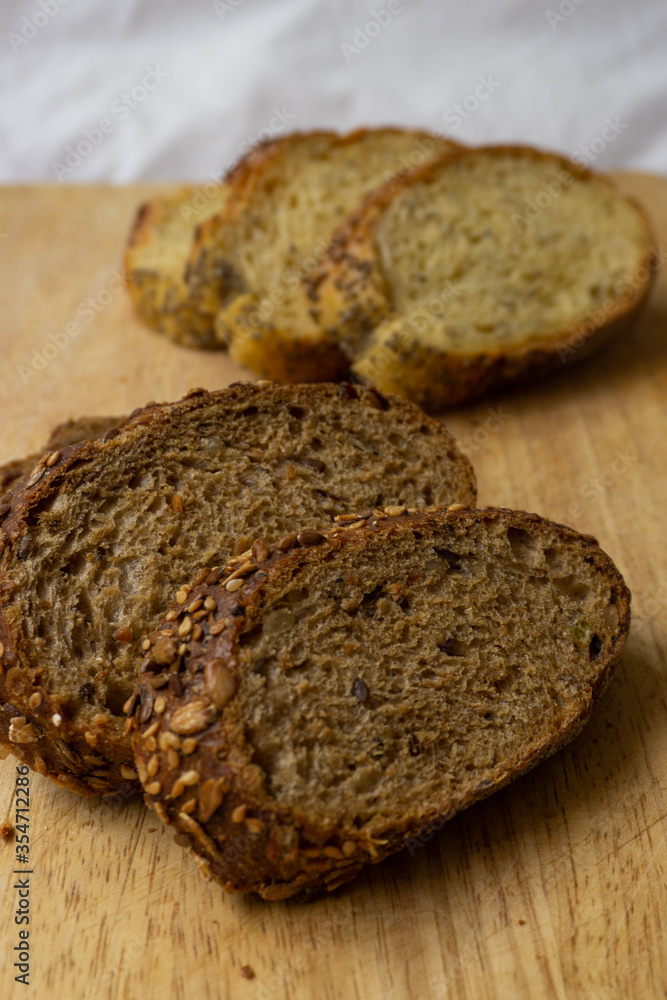 Bread slices on a wooden table. Integral brads. Corn bread. Selective focus. Bread slices on a wooden table. Integral brads. Corn bread. Selective focus.