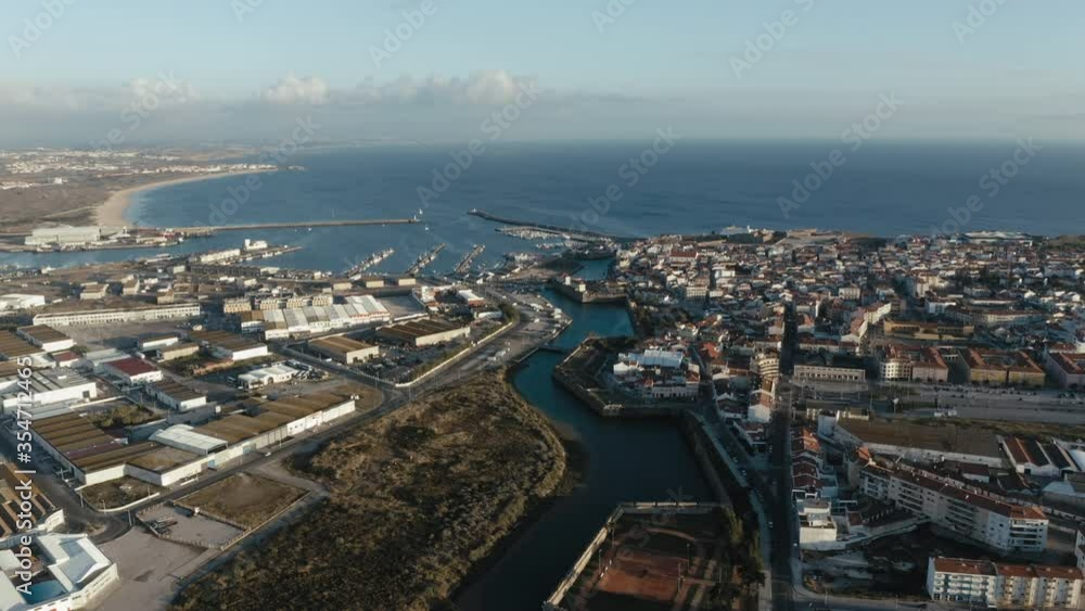 Wide open aerial view of Peniche's stronghold and canal towards the fishing port and marina. Wide open aerial view of Peniche's stronghold and canal towards the fishing port and marina.
