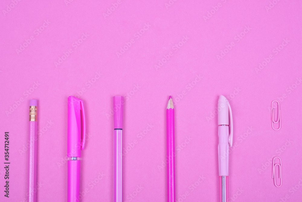Top view of school or office supplies of a pastel pink color on a pastel pink background, copy space for your text (minimal concept) Top view of school or office supplies of a pastel pink color on a pastel pink background, copy space for your text (minimal concept)