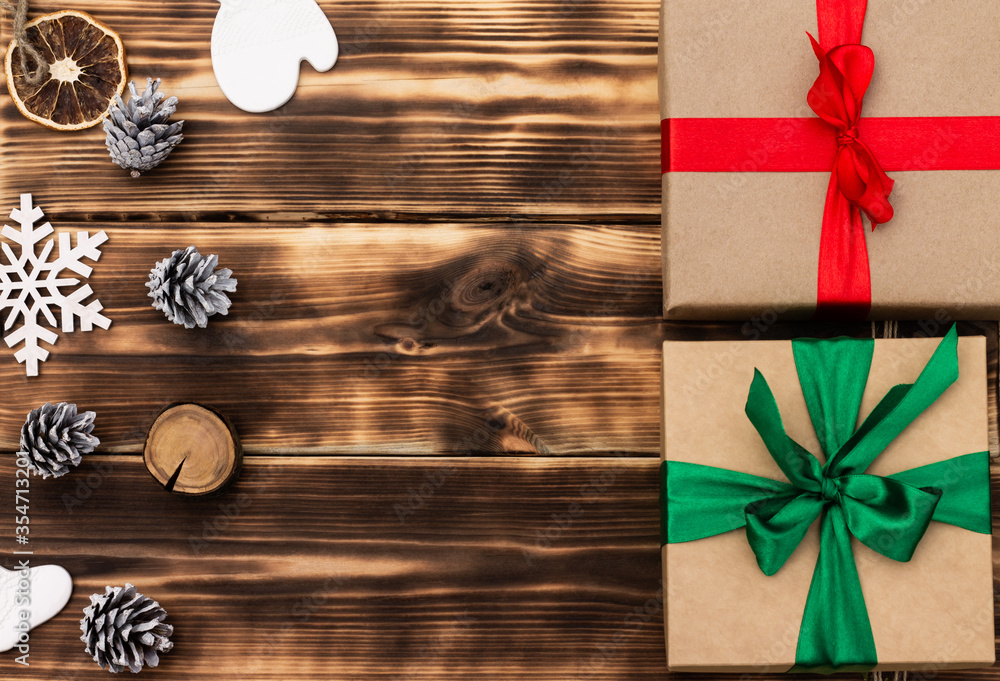 Christmas and New Year. Wooden dark flat lay frame with gifts, Christmas toys and cones. Copy space. Christmas and New Year. Wooden dark flat lay frame with gifts, Christmas toys and cones. Copy space.
