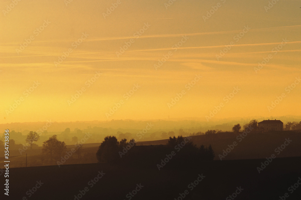 Panorama of a wonderful sunset on the hills of Monferrato,  bathed in warm sunlight, Piedmont, Italy.