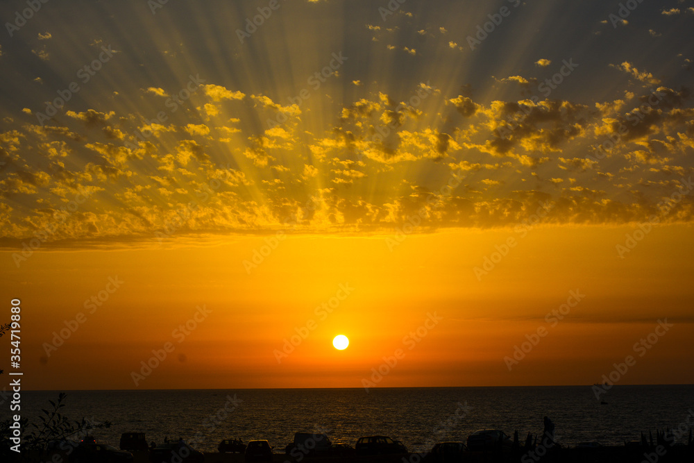 Obraz premium Beautiful sunset above sea or ocean. Vibrant and soft colors, magic light. clouds on the sky. Concept of romantic time on vacation in morocco.