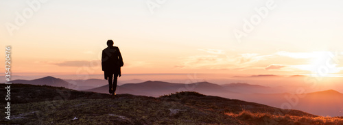 Silhouette of a man photographing against the sunset