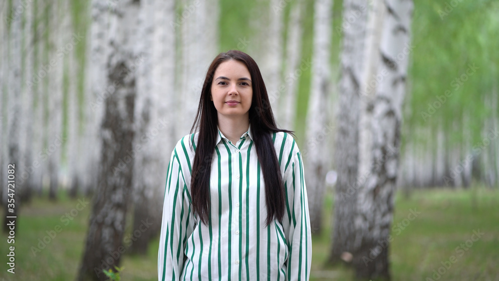 Girl walks in a birch grove on a spring day. Birch tree alley landscape. Girl walks in a birch grove on a spring day. Birch tree alley landscape.