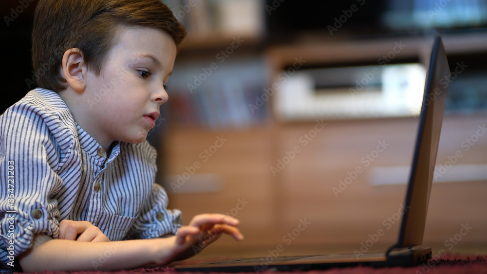 baby boy in blue shirt watching on laptop. baby boy in blue shirt watching on laptop.