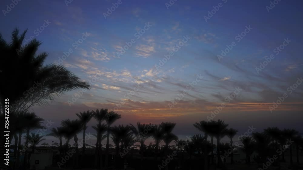 Beautiful landscape with palms on resort beach and sunrise over sea, zoom in timelapse 4k Beautiful landscape with palms on resort beach and sunrise over sea, zoom in timelapse 4k