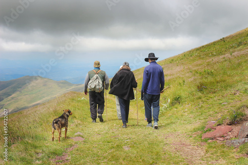 A family hiking on the mountain and racing the weather to return before the storm starts