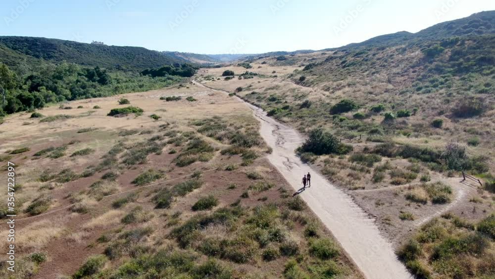 Aerial view of Los Penasquitos Canyon Preserve with tourists, hikers and bikers on the trails,. Urban park with mountain, forest and trails in San Diego, California. USA Aerial view of Los Penasquitos Canyon Preserve with tourists, hikers and bikers on the trails,. Urban park with mountain, forest and trails in San Diego, California. USA