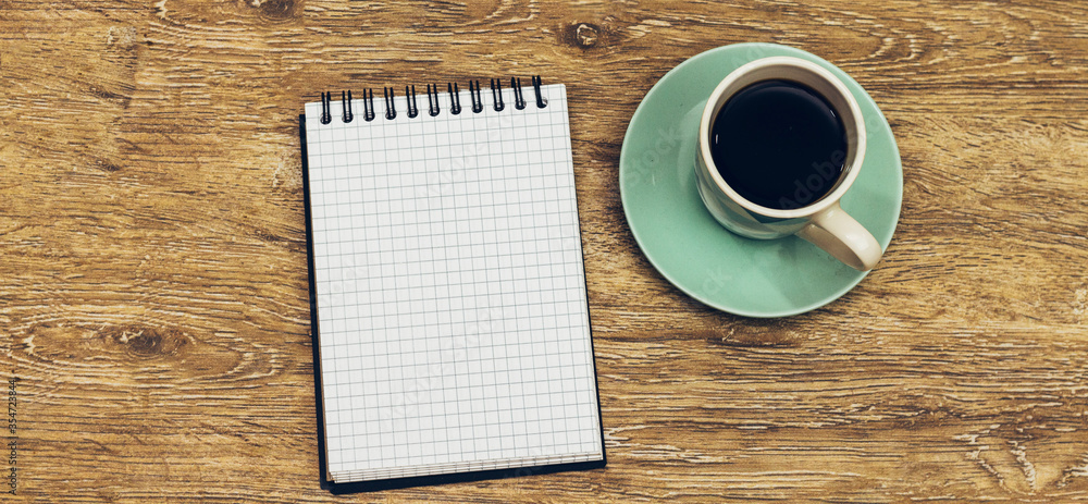 A Blank White Notebook And Coffee On The Desk A Blank White Notebook And Coffee On The Desk