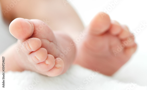 Newborn's feet on white blanket for your a baby shower card