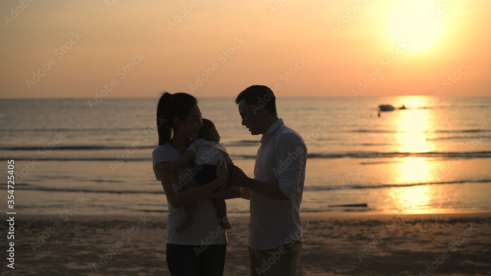 Family concept. Parents raising children on the beach. 4k Resolution.