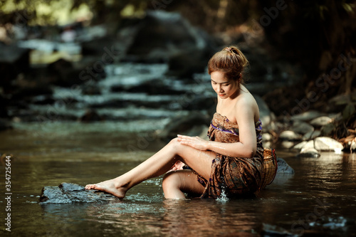 Asian sexy woman washing in streams The girl was bathing in the brook, woman washing in the stream, country girl portrait in outdoors.