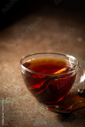 Tea bag in a transparent glass cup with hot water
