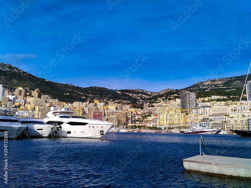 Skyline of Monte Carlo with luxury yachts anchored in the harbor on a sunny day. Monaco-Ville, Monaco.  © Sybille
