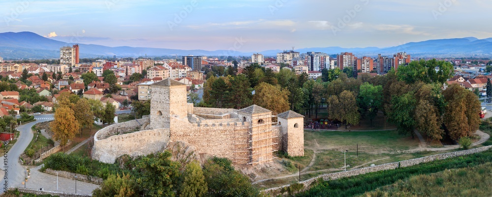 Beautiful panorama of Pirot cityscape, with foreground ancient fortress Momcilov grad and city buildings and houses in the background