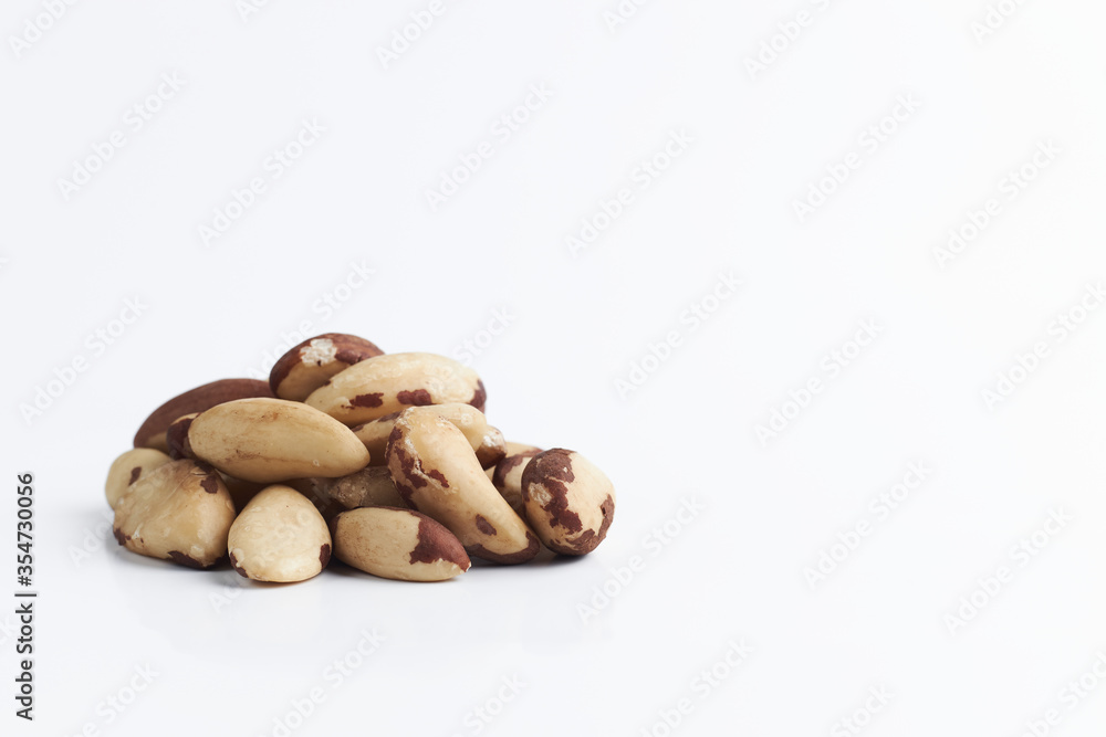 handful of Brazilian walnuton on a white background. close-up of raw nuts. healthy food isolated. copy space for text.