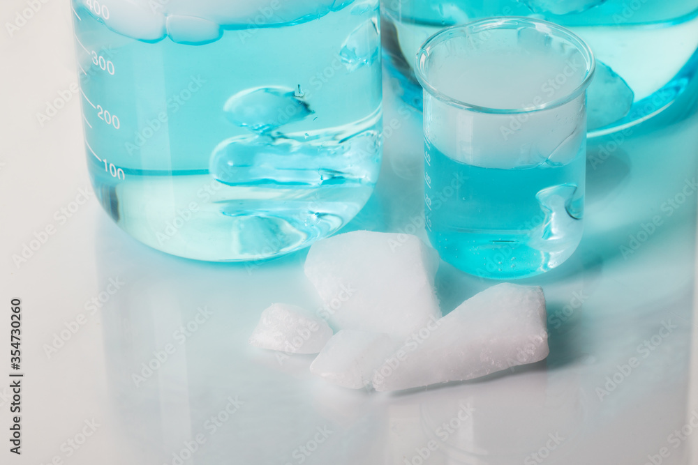 Beakers with blue liquid and white steam. Blocks of carbon dioxide. Experiment with dry ice.
Beakers with blue liquid and white steam. Blocks of carbon dioxide. Experiment with dry ice.