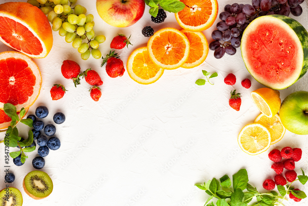 Assorted fresh fruits and berries on white background. Clean eating, healthy life. Top view. Assorted fresh fruits and berries on white background. Clean eating, healthy life. Top view.