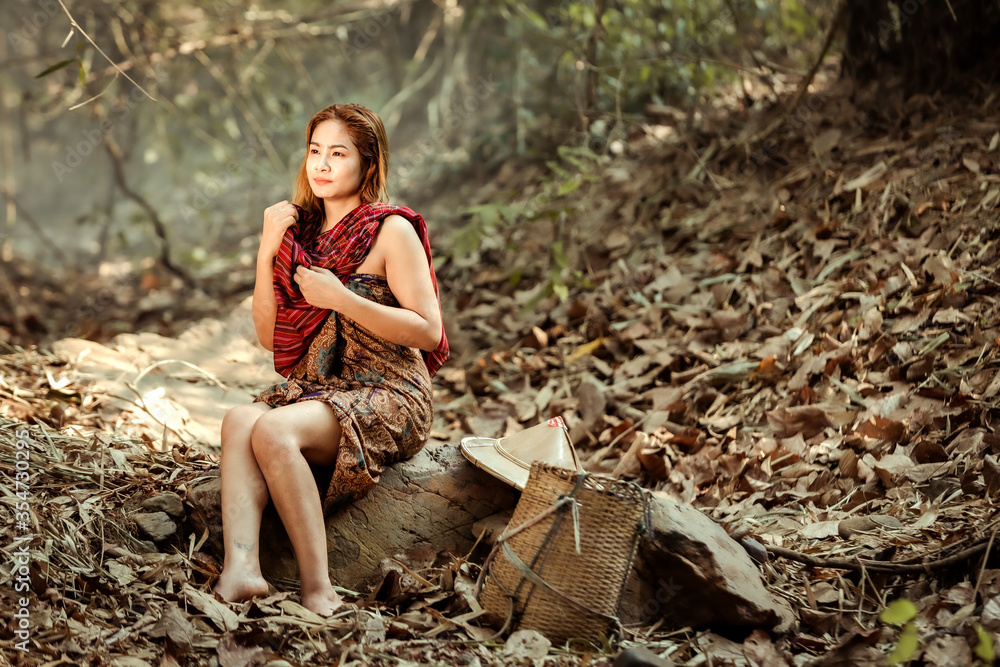 Rural girl Sitting and resting While waiting to shower in the stream In the rural areas of Thailand Rural girl Sitting and resting While waiting to shower in the stream In the rural areas of Thailand