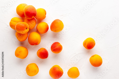 Fresh organic apricots on white background. Vegetarian  clean and healthy eating concept. Flat lay  copy space.