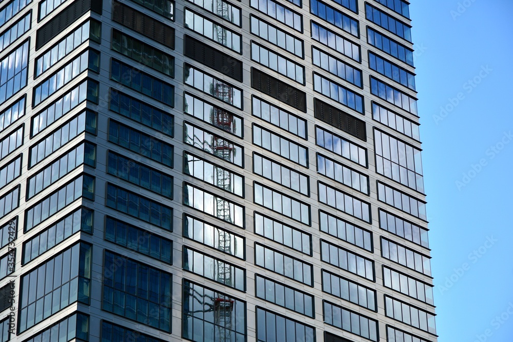 Facade texture of a glass mirrored office building. Fragment of the facade. Modern architecture of the office building. Facade texture of a glass mirrored office building. Fragment of the facade. Modern architecture of the office building.