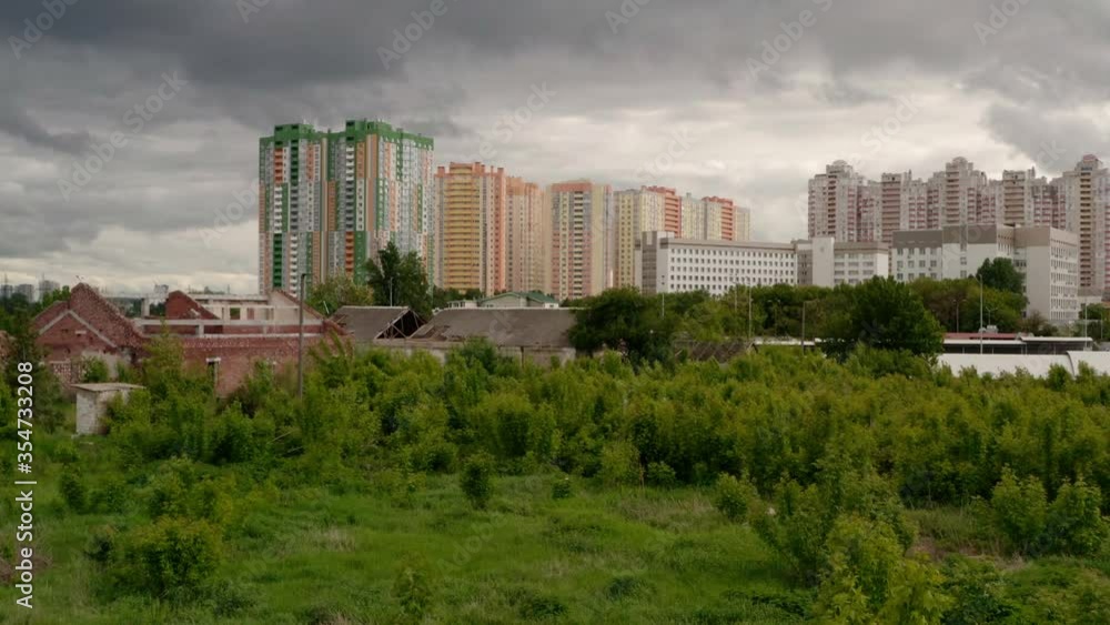 Aerial view. Cityscape with apartments and buildings on the outskirts of the city on a cloudy summer day. View of the northern part of Kiev in Ukraine. City landscape. Urbanization Aerial view. Cityscape with apartments and buildings on the outskirts of the city on a cloudy summer day. View of the northern part of Kiev in Ukraine. City landscape. Urbanization