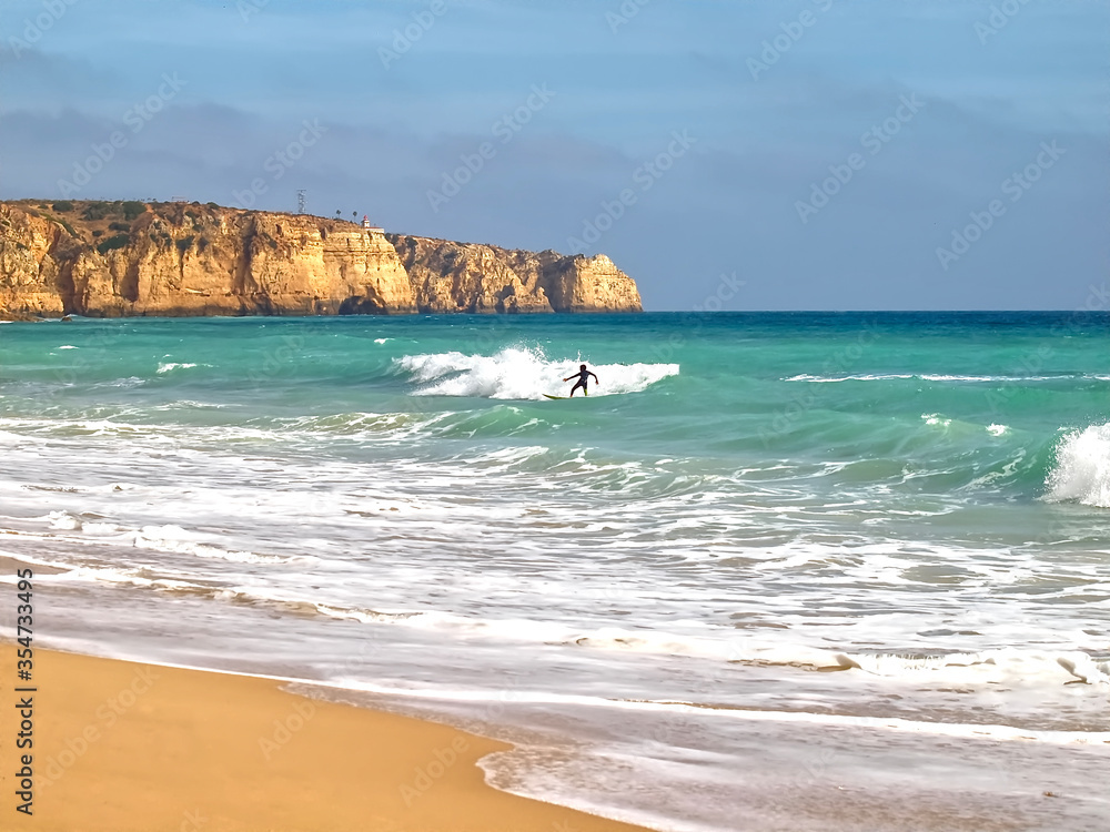 Surfer on his board sporting in the ocean Surfer on his board sporting in the ocean