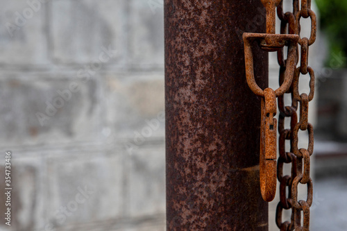 rusty metal chain and carabiner. A leash for guard dogs