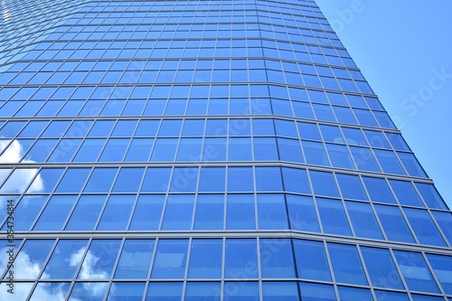 Facade texture of a glass mirrored office building. Fragment of the facade. Modern architecture of the office building.