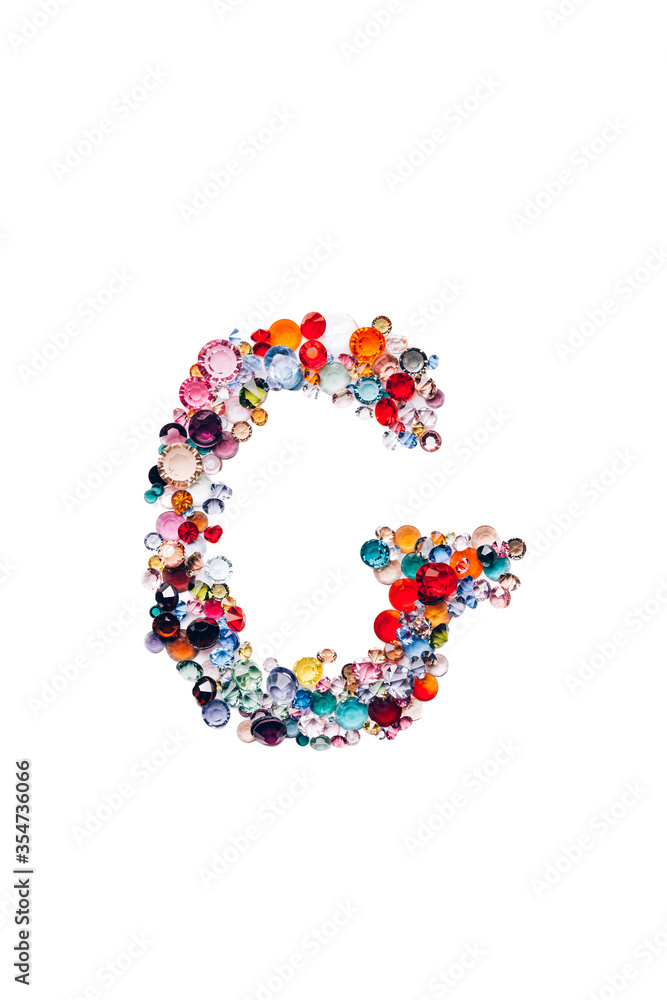 Letter G made from beautiful glass bright gems or crystals on isolated white background