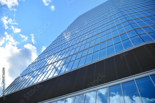 Facade texture of a glass mirrored office building. Fragment of the facade. Modern architecture of the office building.