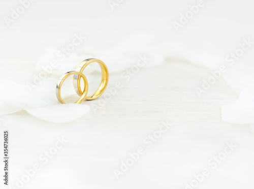 Close-up Wedding rings and white petals