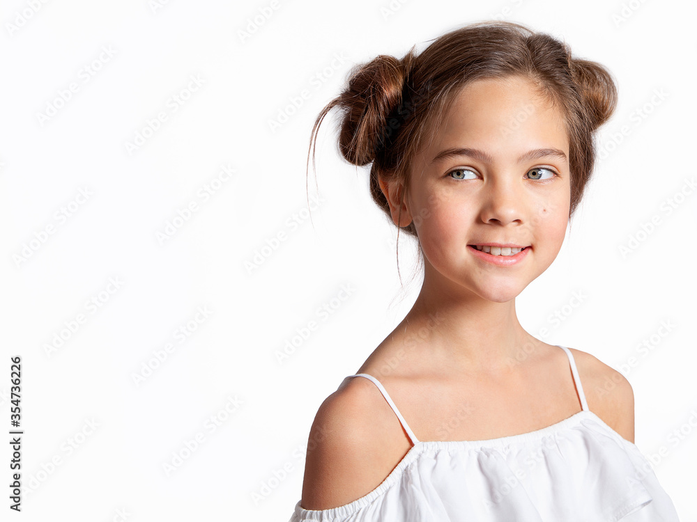 Portrait of a beautiful European blue-eyed teenage girl on a white background. Care for young skin, natural beauty without makeup. The girl smiles and looks away. Portrait of a beautiful European blue-eyed teenage girl on a white background. Care for young skin, natural beauty without makeup. The girl smiles and looks away.