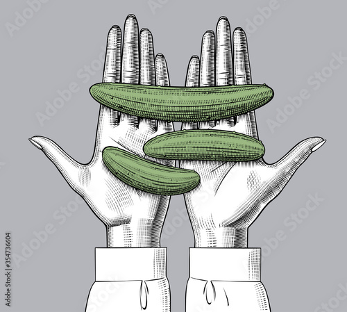 Female hand palms with cucumbers