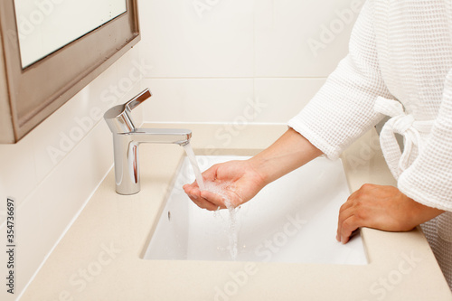 Fototapeta Naklejka Na Ścianę i Meble -  man washing hands in bathroom