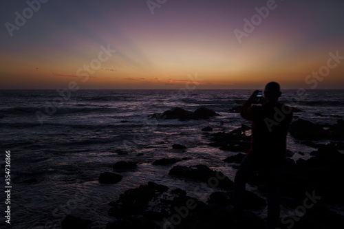 Photographer on the  Pacific coast © kavastudio