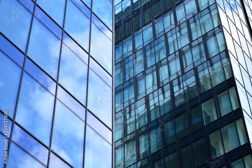 Facade texture of a glass mirrored office building. Fragment of the facade. Modern architecture of the office building.