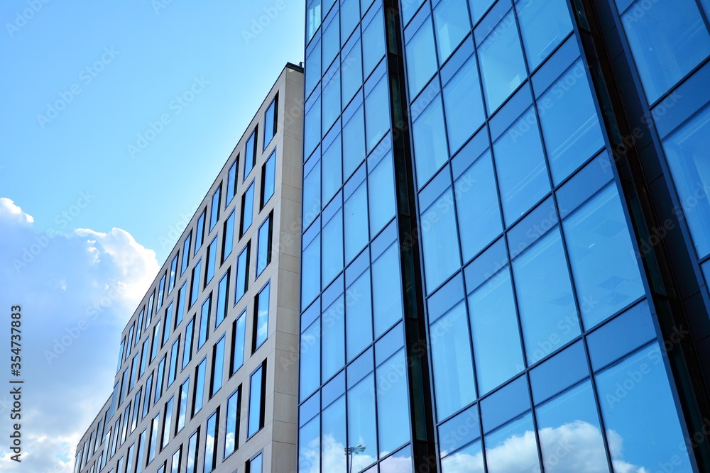 Facade texture of a glass mirrored office building. Fragment of the facade. Modern architecture of the office building. Facade texture of a glass mirrored office building. Fragment of the facade. Modern architecture of the office building.